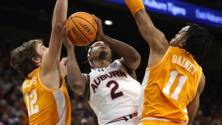 Jan 25, 2025; Auburn, Alabama, USA;  Auburn Tigers guard Denver Jones (2) shoots the ball against Tennessee Volunteers forward Cade Phillips (12) and guard Jordan Gainey (11) during the second half at Neville Arena. Mandatory Credit: John Reed-Imagn Images