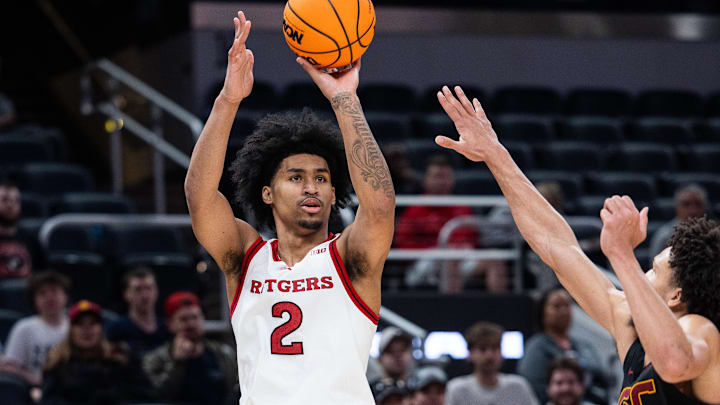 Mar 12, 2025; Indianapolis, IN, USA; Rutgers Scarlet Knights guard Dylan Harper (2) shoots the ball while USC Trojans guard Desmond Claude (1) defends in the second half at Gainbridge Fieldhouse. Mandatory Credit: Trevor Ruszkowski-Imagn Images