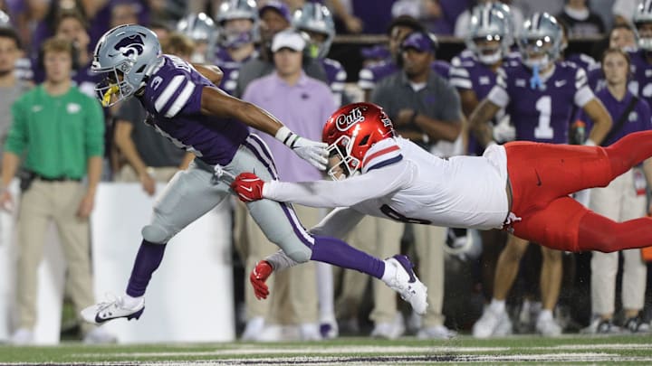 Kansas State Wildcats running back Dylan Edwards (3) leaps away from Arizona Wildcats linebacker Sterling Lane II (8) during the third quarter of the game at Bill Snyder Family Stadium on Friday, September 13, 2024. Kansas State Wildcats running back Dylan Edwards (3) leaps away from Arizona Wildcats linebacker Sterling Lane II (8) during the third quarter of the game at Bill Snyder Family Stadium on Friday, September 13, 2024.