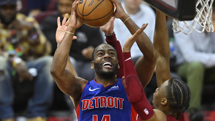 Jan 31, 2024; Cleveland, Ohio, USA; Detroit Pistons guard Alec Burks (14) shoots beside Cleveland Cavaliers forward Isaac Okoro (35) in the fourth quarter at Rocket Mortgage FieldHouse. Mandatory Credit: David Richard-USA TODAY Sports