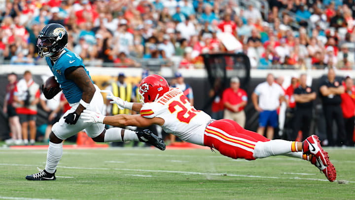 Aug 10, 2024; Jacksonville, Florida, USA; Jacksonville Jaguars running back Travis Etienne Jr. (1) runs the ball in for a touchdown as Kansas City Chiefs linebacker Drue Tranquill (23) defends during the first quarter at EverBank Stadium. Mandatory Credit: Douglas DeFelice-Imagn Images