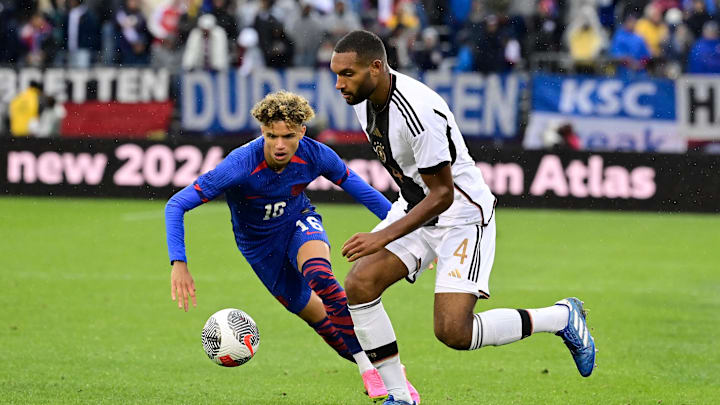 Oct 14, 2023; East Hartford, Connecticut, USA; United States defender Kevin Paredes (16) and Germany defender Jonathan Tah (4) battle for control of the ball during the second half at Pratt & Whitney Stadium. Mandatory Credit: Eric Canha-Imagn Images