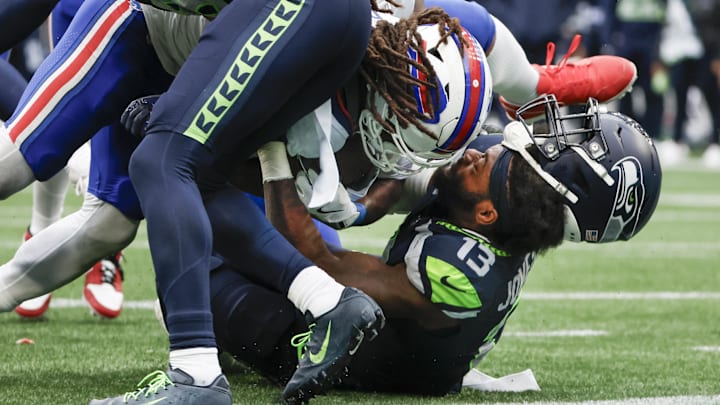 Oct 27, 2024; Seattle, Washington, USA; Buffalo Bills running back James Cook (4) rushes for a touchdown against Seattle Seahawks linebacker Ernest Jones IV (13) during the fourth quarter at Lumen Field. Mandatory Credit: Joe Nicholson-Imagn Images