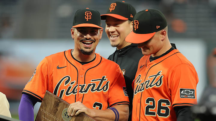 Sep 26, 2025; San Francisco, California, USA; San Francisco Giants shortstop Willy Adames (left) with Wilmer Flores (center) and Matt Chapman (right) as he receives the Willie Mac award before the game against the Colorado Rockies at Oracle Park. Mandatory Credit: Kelley L Cox-Imagn Images