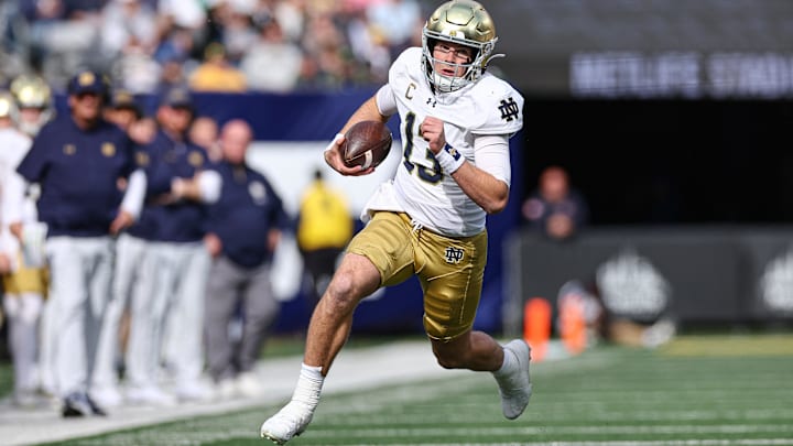 Oct 26, 2024; East Rutherford, New Jersey, USA;Notre Dame Fighting Irish quarterback Riley Leonard (13) carries the ball during the first half against the Navy Midshipmen at MetLife Stadium. Mandatory Credit: Vincent Carchietta-Imagn Images Oct 26, 2024; East Rutherford, New Jersey, USA;Notre Dame Fighting Irish quarterback Riley Leonard (13) carries the ball during the first half against the Navy Midshipmen at MetLife Stadium. Mandatory Credit: Vincent Carchietta-Imagn Images