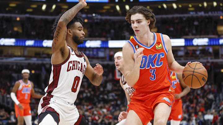 Jan 13, 2023; Chicago, Illinois, USA; Oklahoma City Thunder guard Josh Giddey (3) is defended by Chicago Bulls guard Coby White (0) : Kamil Krzaczynski-USA TODAY Sports