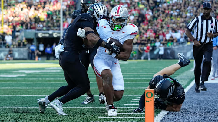 Oct 12, 2024; Eugene, Oregon, USA; Ohio State Buckeyes running back Quinshon Judkins (1) is forced out of bounds by Oregon Ducks defensive back Tysheem Johnson (0) during the first half of the NCAA football game at Autzen Stadium