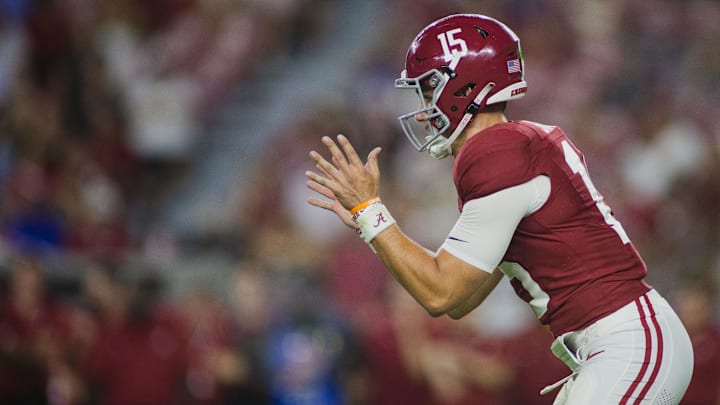 Aug 31, 2024; Tuscaloosa, Alabama, USA;  Alabama Crimson Tide quarterback Ty Simpson (15) reaches out for a snap during the fourth quarter at Bryant-Denny Stadium. 