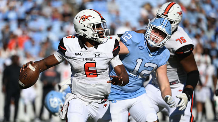 Nov 4, 2023; Chapel Hill, North Carolina, USA; Campbell Fighting Camels quarterback Hajj-Malik Williams (6) looks to pass as North Carolina Tar Heels defensive lineman Beau Atkinson (12) pressures in the third quarter at Kenan Memorial Stadium. Mandatory Credit: Bob Donnan-Imagn Images Nov 4, 2023; Chapel Hill, North Carolina, USA; Campbell Fighting Camels quarterback Hajj-Malik Williams (6) looks to pass as North Carolina Tar Heels defensive lineman Beau Atkinson (12) pressures in the third quarter at Kenan Memorial Stadium. Mandatory Credit: Bob Donnan-Imagn Images