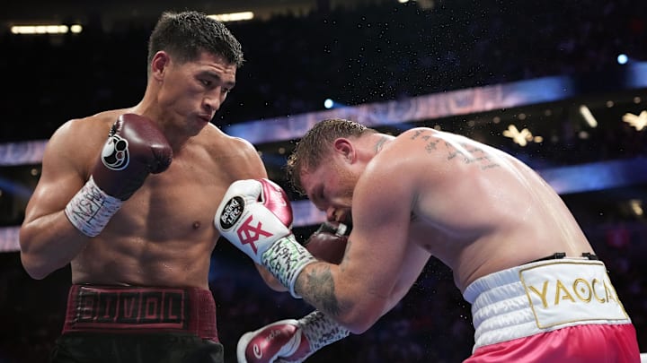 Canelo Alvarez (pink trunks) and Dimitry Bivol (black trunks) box during their light heavyweight championship bout at T-Mobile Arena. Canelo Alvarez (pink trunks) and Dimitry Bivol (black trunks) box during their light heavyweight championship bout at T-Mobile Arena.