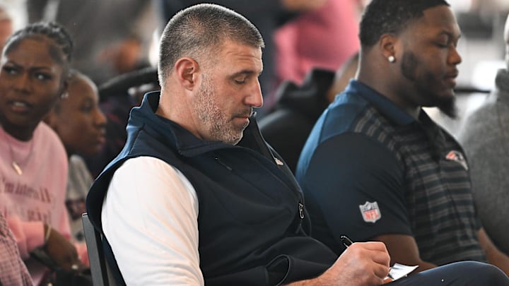 Mar 13, 2025; Foxborough, MA, USA; New England Patriots head coach Mike Vrabel takes notes at a press conference at the GP Atrium at Gillette Stadium. Mandatory Credit: Eric Canha-Imagn Images