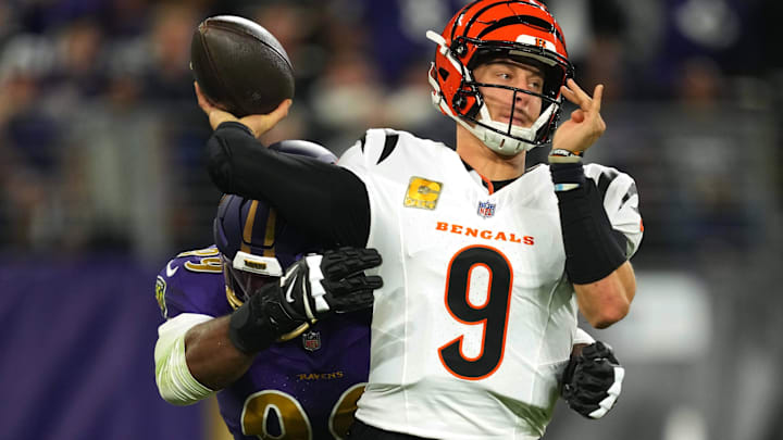 Nov 7, 2024; Baltimore, Maryland, USA; Cincinnati Bengals quarterback Joe Burrow (9) is pressured by Baltimore Ravens linebacker Odafe Oweh (99) during the first quarter at M&T Bank Stadium. Mandatory Credit: Mitch Stringer-Imagn Images