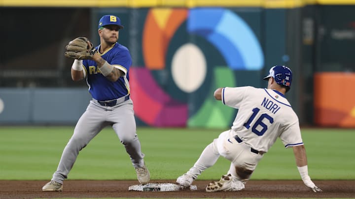 Mar 7, 2026; Houston, TX, United States; Italy left fielder Dante Nori (16) is out at second base as Brazil second baseman Lucas Rojo (15) fields a throw during the third inning at Daikin Park. Mandatory Credit: Troy Taormina-Imagn Images