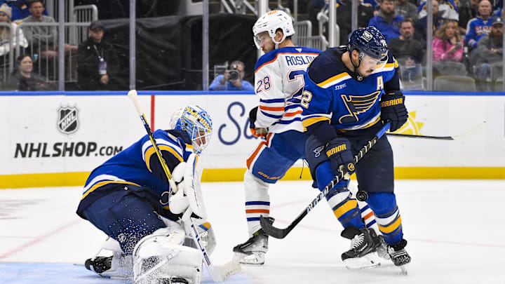 Nov 3, 2025; St. Louis, Missouri, USA; St. Louis Blues defenseman Justin Faulk (72) and goaltender Jordan Binnington (50) defend the n et against Edmonton Oilers center Jack Roslovic (28) during the third period at Enterprise Center. Mandatory Credit: Jeff Curry-Imagn Images