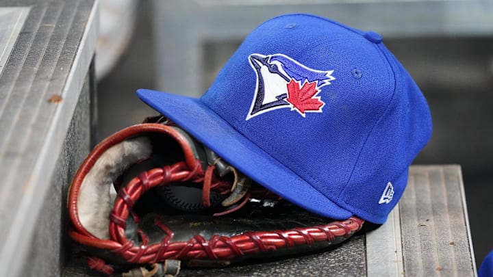 Apr 16, 2025; Toronto, Ontario, CAN; A Toronto Blue Jays hat and glove in the dugout during a game against the Atlanta Braves at Rogers Centre. 