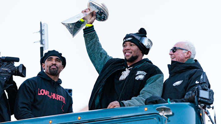 Philadelphia Eagles running back Saquon Barkley lifts the Lombardi Trophy during the Super Bowl LIX championship parade and rally.
