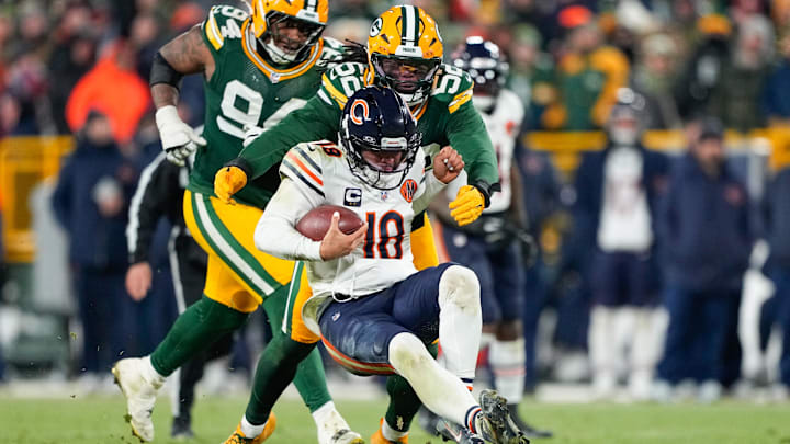 Dec 7, 2025; Green Bay, Wisconsin, USA; Chicago Bears quarterback Caleb Williams (18) is tackled by Green Bay Packers defensive lineman Rashan Gary (52) in the third quarter at Lambeau Field. Mandatory Credit: Jeff Hanisch-Imagn Images