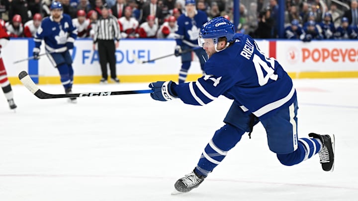Mar 20, 2026; Toronto, Ontario, CAN;  Toronto Maple Leafs defenseman Morgan Rielly (44) hits a slapshot against the Carolina Hurricanes in the first period at Scotiabank Arena. Mandatory Credit: Dan Hamilton-Imagn Images