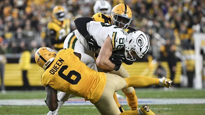 Oct 26, 2025; Pittsburgh, Pennsylvania, USA; Green Bay Packers tight end John FitzPatrick (86) is tackled by Pittsburgh Steelers linebacker Patrick Queen (6) and safety Chuck Clark (21) during the second quarter at Acrisure Stadium. Mandatory Credit: Barry Reeger-Imagn Images