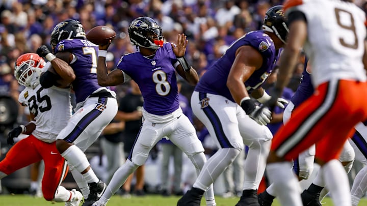 Sep 14, 2025; Baltimore, Maryland, USA; Baltimore Ravens quarterback Lamar Jackson (8) throws a touchdown pass during the fourth quarter at M&T Bank Stadium. Mandatory Credit: Peter Casey-Imagn Images