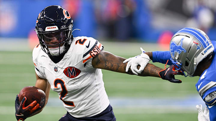 Sep 14, 2025; Detroit, Michigan, USA; Chicago Bears wide receiver DJ Moore (2) carries the ball defended by Detroit Lions cornerback D.J. Reed (4) during the first quarter of the game at Ford Field. Mandatory Credit: Lon Horwedel-Imagn Images