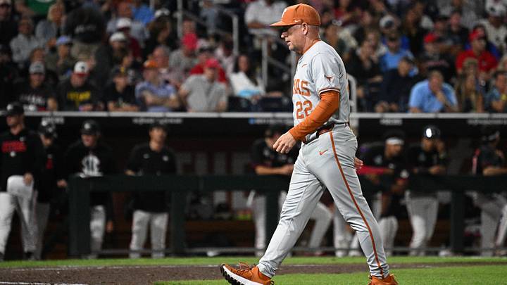 Texas Longhorns coach Jim Schlossnagle walks back to the dugout against the Georgia Bulldogs in the College World Series. Texas Longhorns coach Jim Schlossnagle walks back to the dugout against the Georgia Bulldogs in the College World Series.
