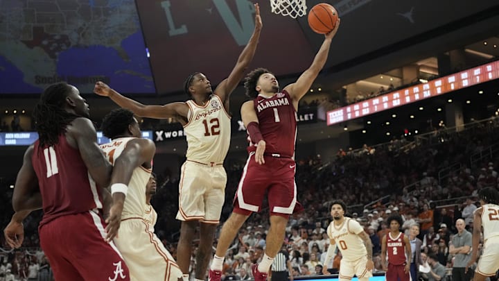 Feb 11, 2025; Austin, Texas, USA; Alabama Crimson Tide guard Mark Sears (1) lays in a basket while defended by Texas Longhorns guard Tramon Mark (12) during the second half at Moody Center. Mandatory Credit: Scott Wachter-Imagn Images