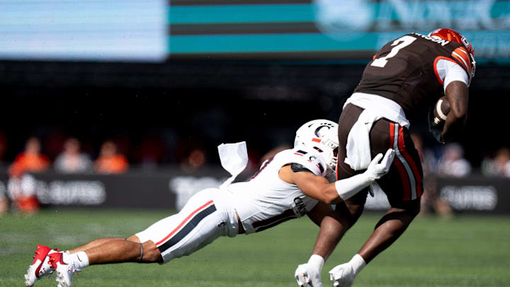 Cincinnati Bearcats safety Tayden Barnes (10) tackles Bowling Green Falcons tight end Jyrin Johnson (7) in the second quarter of the NCAA football game between the Cincinnati Bearcats and Bowling Green Falcons at Nippert Stadium in Cincinnati on Sept. 6, 2025.