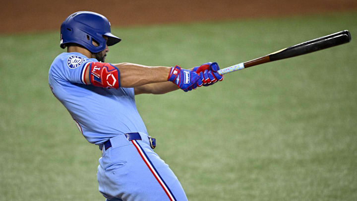 Sep 22, 2024; Arlington, Texas, USA; Texas Rangers center fielder Leody Taveras (3) hits a single against the Seattle Mariners during the ninth inning at Globe Life Field. 
