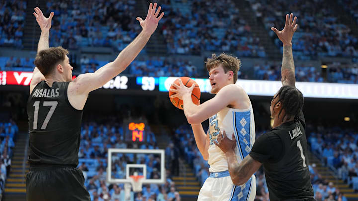 Feb 28, 2026; Chapel Hill, North Carolina, USA; North Carolina Tar Heels center Henri Veesaar (13) with the ball as Virginia Tech Hokies guard Neoklis Avdalas (17) and forward Tobi Lawal (1) defend in the second half at Dean E. Smith Center. Mandatory Credit: Bob Donnan-Imagn Images