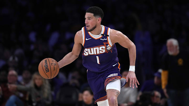 Mar 16, 2025; Los Angeles, California, USA; Phoenix Suns guard Devin Booker (1) dribbles the ball against the Los Angeles Lakers in the second half at Crypto.com Arena. Mandatory Credit: Kirby Lee-Imagn Images