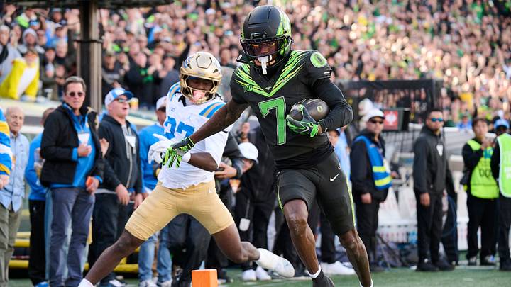 Oct 10, 2026; Eugene, Oregon, USA; Oregon Ducks wide receiver Evan Stewart (7) scores a touchdown during the second half against UCLA Bruins defensive back Ta'shawn James (27) at Autzen Stadium. Mandatory Credit: Troy Wayrynen-Imagn Images