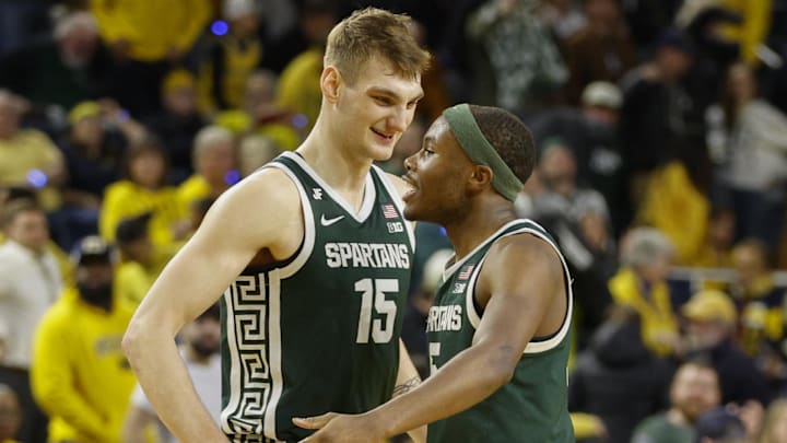 Feb 21, 2025; Ann Arbor, Michigan, USA; Michigan State Spartans center Carson Cooper (15) and guard Tre Holloman (5) react at the end of the second half against the Michigan Wolverines at Crisler Center. Mandatory Credit: Brian Bradshaw Sevald-Imagn Images