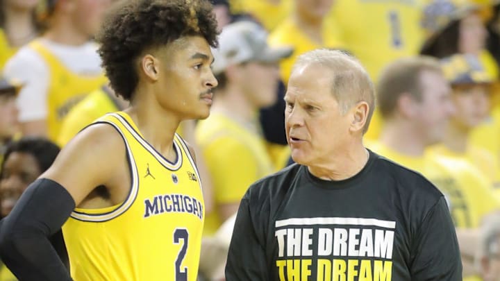 Michigan coach John Beilein talks with guard Jordan Poole during a game against Minnesota, Jan. 22,