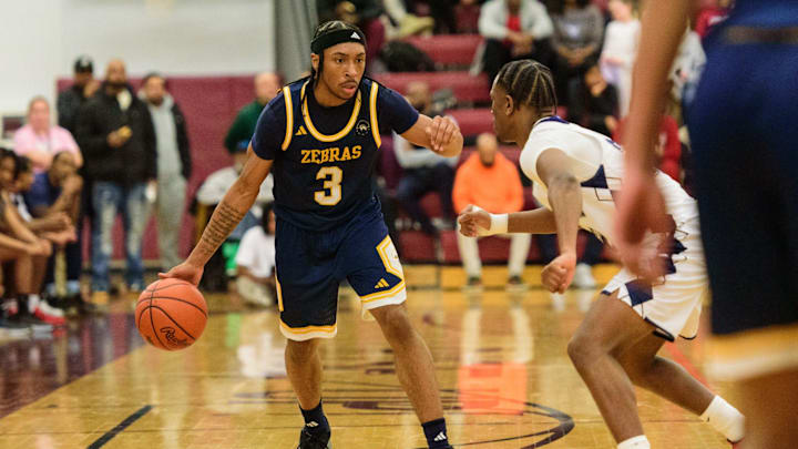Wayne Memorial's Carlos Medlock Jr. dribbles during the Division 1 boys basketball regional semifinal on Tuesday, March 4, 2025, at Detroit Renaissance High School.