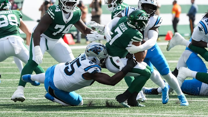 Oct 19, 2025; East Rutherford, New Jersey, USA; New York Jets quarterback Justin Fields (7) is brought down by Carolina Panthers defensive end Derrick Brown (95) and outside linebacker Nic Scourton (11) at MetLife Stadium. Oct 19, 2025; East Rutherford, New Jersey, USA; New York Jets quarterback Justin Fields (7) is brought down by Carolina Panthers defensive end Derrick Brown (95) and outside linebacker Nic Scourton (11) at MetLife Stadium.
