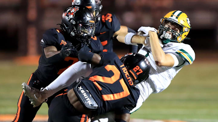 Massillon defenders tackle St. Edward during action Friday night, September 19, 2025 at Paul Brown Tiger Stadium. Ed Hall Jr. / Special To The Repository
