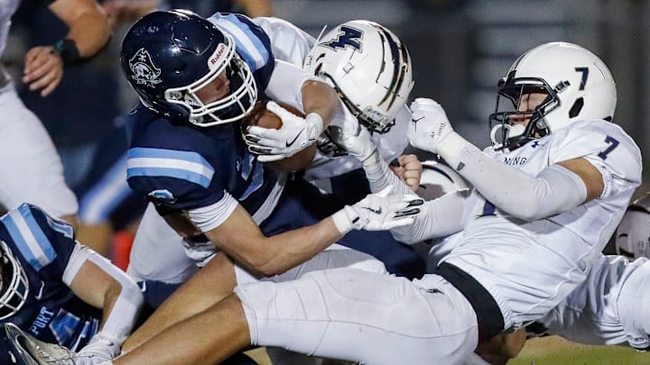 Appleton North High School's Ben Wenzel (7) tackles Bay Port High School's Tommy Kemen (3) during a WIAA Division 1 first round playoff game on Friday, October 24, 2025, at Bay Port High School in Suamico, Wis. Bay Port won the game, 41-6.