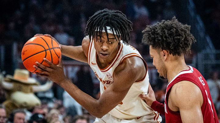 Texas Longhorns guard Tre Johnson (20) looks for an opening as Alabama Crimson Tide guard Mark Sears (1) defends in the first half as the Texas Longhorns take on the Crimson Tide at the Moody Center, Feb. 11, 2025. Texas Longhorns guard Tre Johnson (20) looks for an opening as Alabama Crimson Tide guard Mark Sears (1) defends in the first half as the Texas Longhorns take on the Crimson Tide at the Moody Center, Feb. 11, 2025.