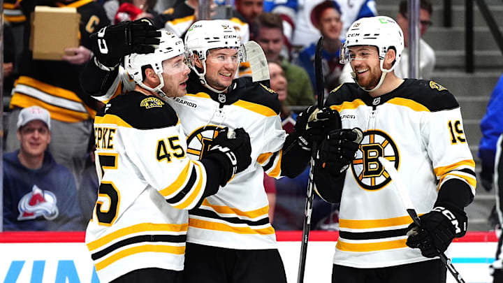 Oct 16, 2024; Denver, Colorado, USA; Boston Bruins left wing Cole Koepke (45) celebrates his goal with defenseman Andrew Peeke (52) and center John Beecher (19) in the first period against the Colorado Avalanche at Ball Arena. Mandatory Credit: Ron Chenoy-Imagn Images