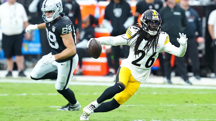 Oct 13, 2024; Paradise, Nevada, USA; Pittsburgh Steelers cornerback Donte Jackson (26) runs the ball back after intercepting a pass intended for Las Vegas Raiders tight end Brock Bowers (89) during the third quarter at Allegiant Stadium. Mandatory Credit: Stephen R. Sylvanie-Imagn Images