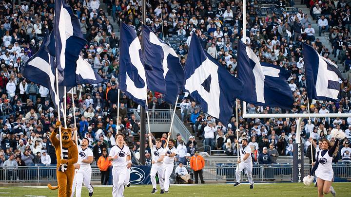 The Penn State Nittany Lion mascot and cheerleaders run across the field before a game against the Michigan State Spartans at Beaver Stadium. The Penn State Nittany Lion mascot and cheerleaders run across the field before a game against the Michigan State Spartans at Beaver Stadium.