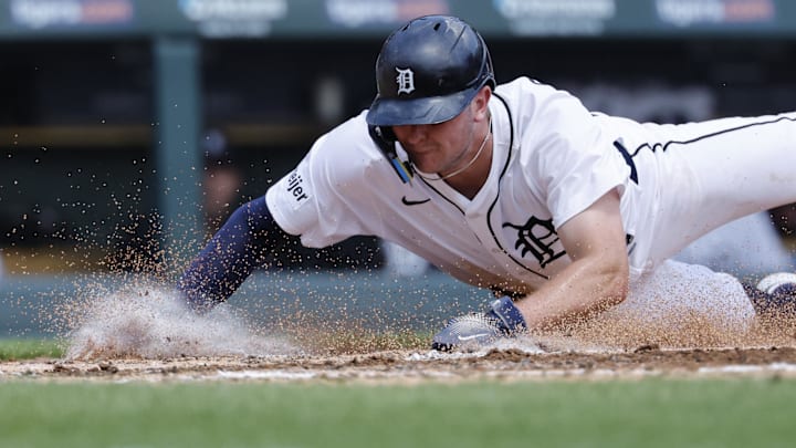 Detroit Tigers second baseman Trey Sweeney (27) dives in safe at home in the second inning against the Los Angeles Angels at Comerica Park.