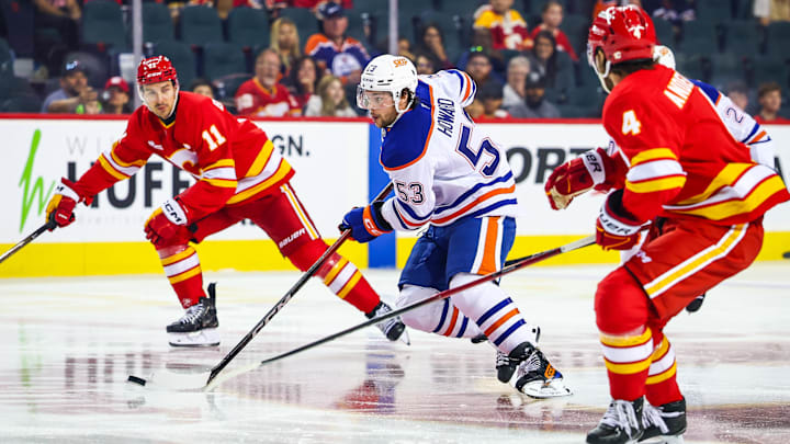 Sep 21, 2025; Calgary, Alberta, CAN; Edmonton Oilers left wing Isaac Howard (53) controls the puck against the Calgary Flames during the first period at Scotiabank Saddledome. Mandatory Credit: Sergei Belski-Imagn Images