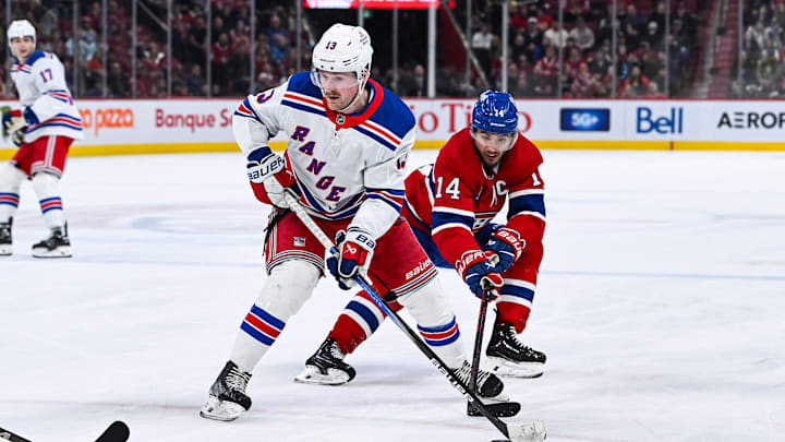 Jan 19, 2025; Montreal, Quebec, CAN; Montreal Canadiens center Nick Suzuki (14) defends the puck against New York Rangers left wing Alexis Lafreniere (13) during the third period at Bell Centre. Mandatory Credit: David Kirouac-Imagn Images