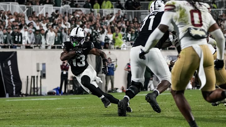 Sep 6, 2025; East Lansing, Michigan, USA; Michigan State wide receiver Chrishon McCray (13) runs the ball in the fourth quarter at Spartan Stadium. Mandatory Credit: Brendan Mullin-Imagn Images