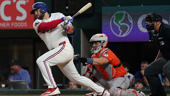 May 15, 2025; Arlington, Texas, USA; Texas Rangers first baseman Jake Burger (21) hits a single during the eighth inning against the Houston Astros at Globe Life Field. May 15, 2025; Arlington, Texas, USA; Texas Rangers first baseman Jake Burger (21) hits a single during the eighth inning against the Houston Astros at Globe Life Field.