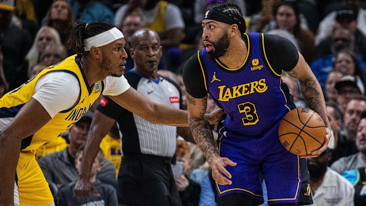 Mar 29, 2024; Indianapolis, Indiana, USA; Los Angeles Lakers forward Anthony Davis (3) dribbles the ball while  Indiana Pacers center Myles Turner (33) defends in the first half at Gainbridge Fieldhouse. Mandatory Credit: Trevor Ruszkowski-Imagn Images