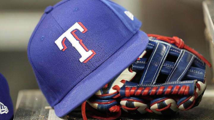 Jul 26, 2024; Toronto, Ontario, CAN; A hat and glove of a Texas Rangers player during a game against the Toronto Blue Jays at Rogers Centre. Jul 26, 2024; Toronto, Ontario, CAN; A hat and glove of a Texas Rangers player during a game against the Toronto Blue Jays at Rogers Centre.