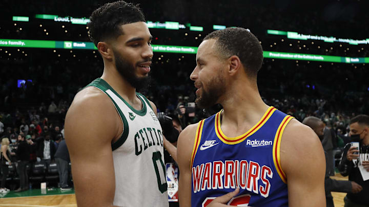 Boston Celtics forward Jayson Tatum (0) talks with Golden State Warriors guard Stephen Curry (30) after their game at TD Garden.